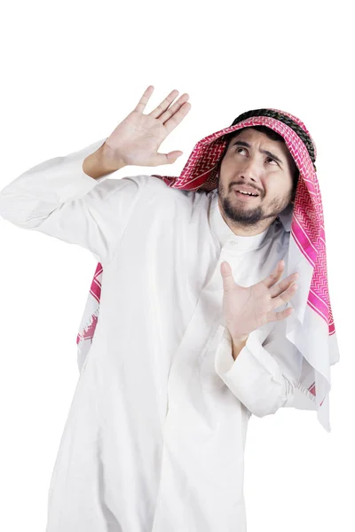 Young Arabian man looks scared in the studio — Stock Photo, Image