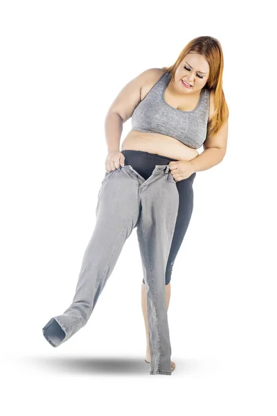 Overweight woman wearing her small jeans — Stock Photo, Image