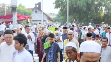 JAKARTA - Indonesia. February 14, 2020: Crowded Muslim men walking back to home after praying together at Eid Al Fitr day