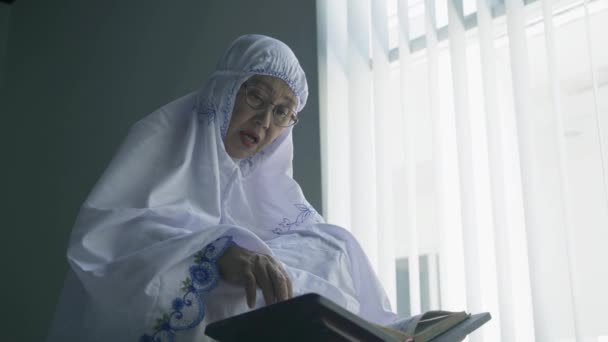 Χαμηλή Γωνία Άποψη Της Ηλικιωμένης Γυναίκας Που Διαβάζει Κοράνι Μετά — Αρχείο Βίντεο