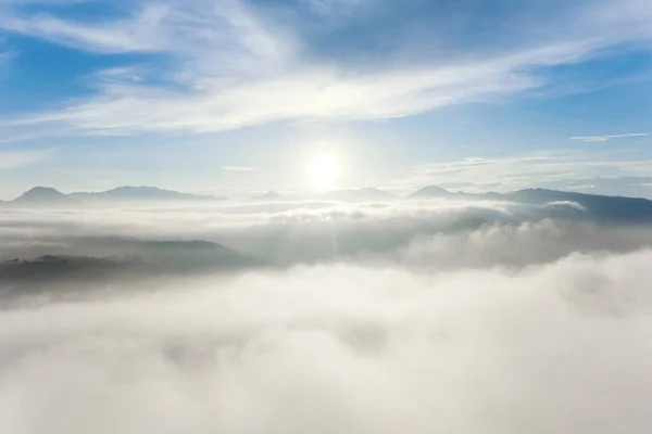 Zonsopgang met heldere lucht en pluizige bewolking over heuvels — Stockfoto