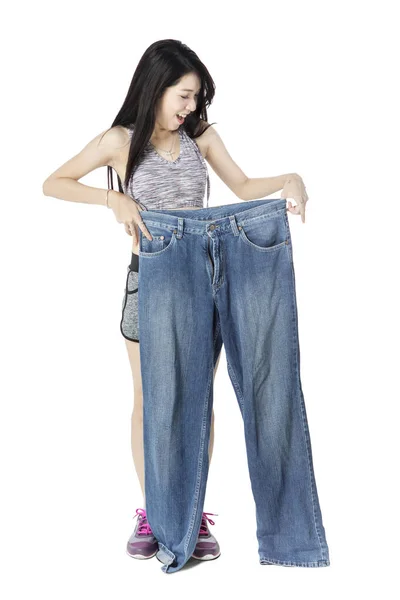 Felice giovane donna in possesso di un vecchio jeans — Foto Stock