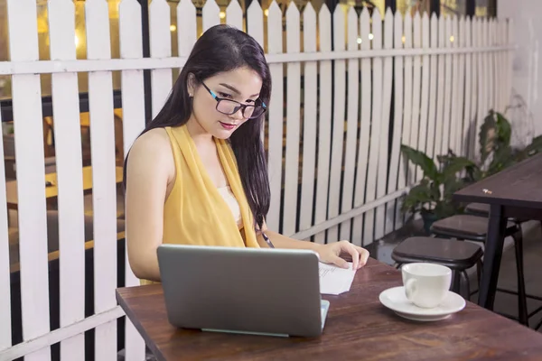 College student writing on paper in cafe — 스톡 사진