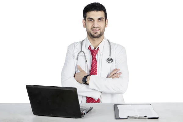 Männlicher Arzt faltet Hand auf seinem Schreibtisch — Stockfoto