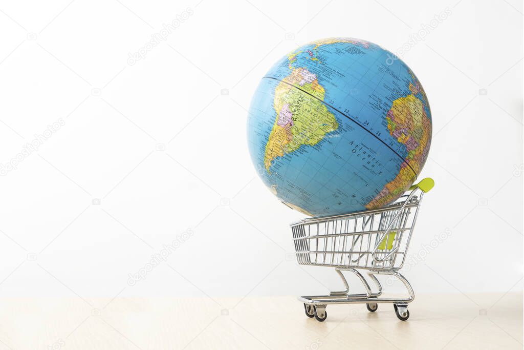 Globe on the shopping cart, isolated on white background
