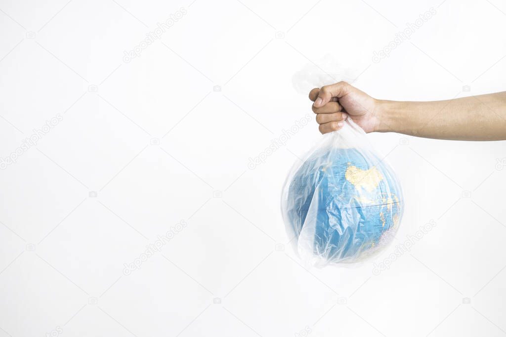 Hand holding globe in plastic bag, isolated on white background