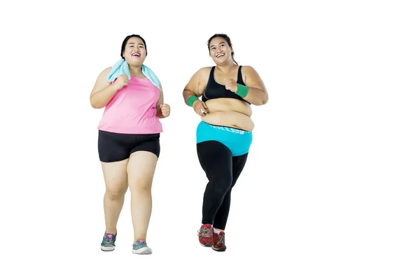 Two Young Overweight Women Running Jogging Together Studio Isolated White — Stock Photo, Image