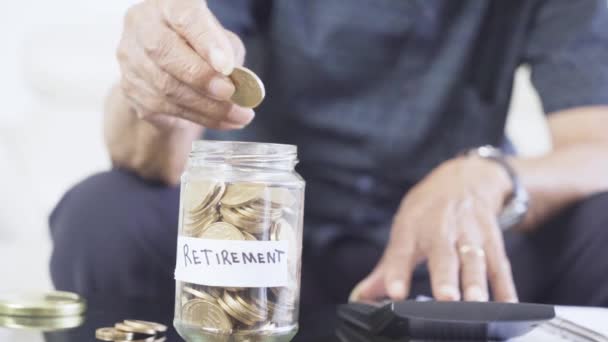 Senior Man Hands Use Calculator Saving Jar — Stock video