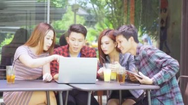 Kafede dizüstü bilgisayarla tartışan mutlu gençler