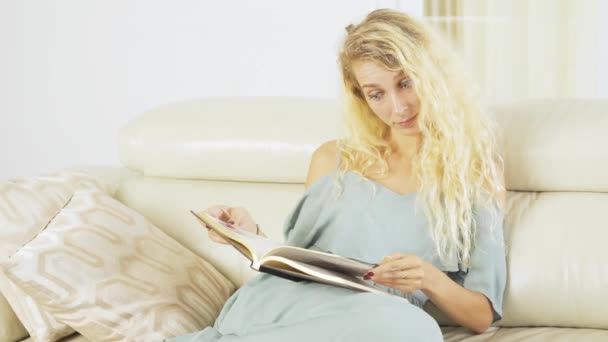 Woman Reading Book While Sitting Sofa Living Room Home — Stock Video