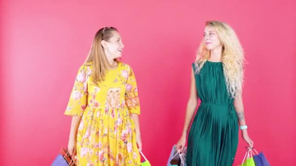 Two Young Women Carries Shopping Bags Studio — Stock Video