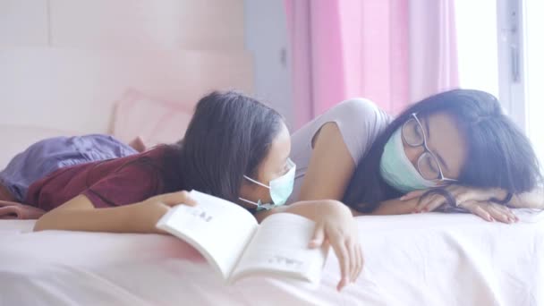 Retrato Joven Madre Hija Leyendo Libro Cama Mientras Llevaba Máscara — Vídeos de Stock