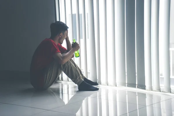 Portrait Frustrated Boy Sitting Curtain While Holding Beer Bottle — Stock Photo, Image