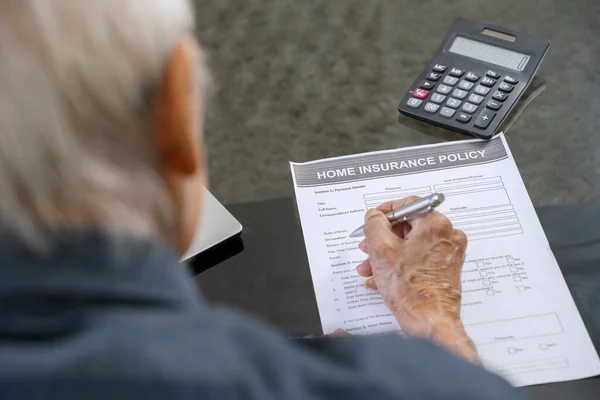 Senior Man Fyller Hemförsäkring Formulär Bordet Hemma — Stockfoto