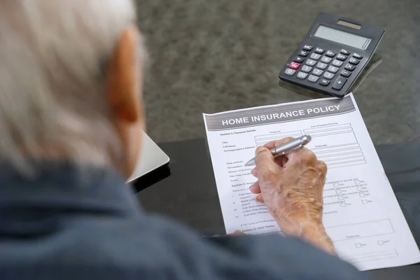 Senior Man Vult Thuis Verzekeringsformulier Tafel Thuis — Stockfoto