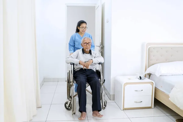 Portrait Young Woman Pushing Her Father Wheelchair Bed Room While — Stock Photo, Image