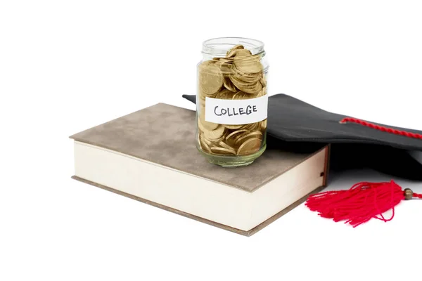 Book Jar Full Coins Graduation Hat Table Isolated White Background — Stock Photo, Image