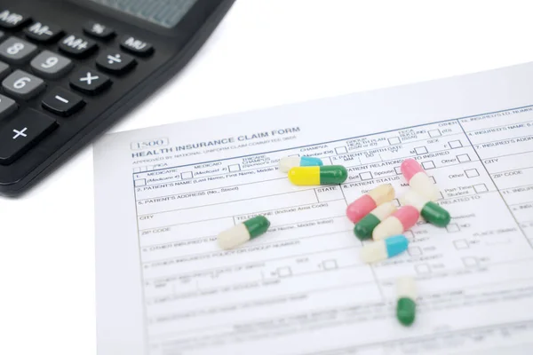 Closeup Health Insurance Claim Form Pills Calculator Table — Stock Photo, Image