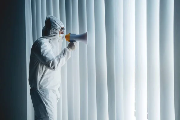 Portrait Man Wearing Hazmat Suit While Shouting Megaphone Window — Stock Photo, Image