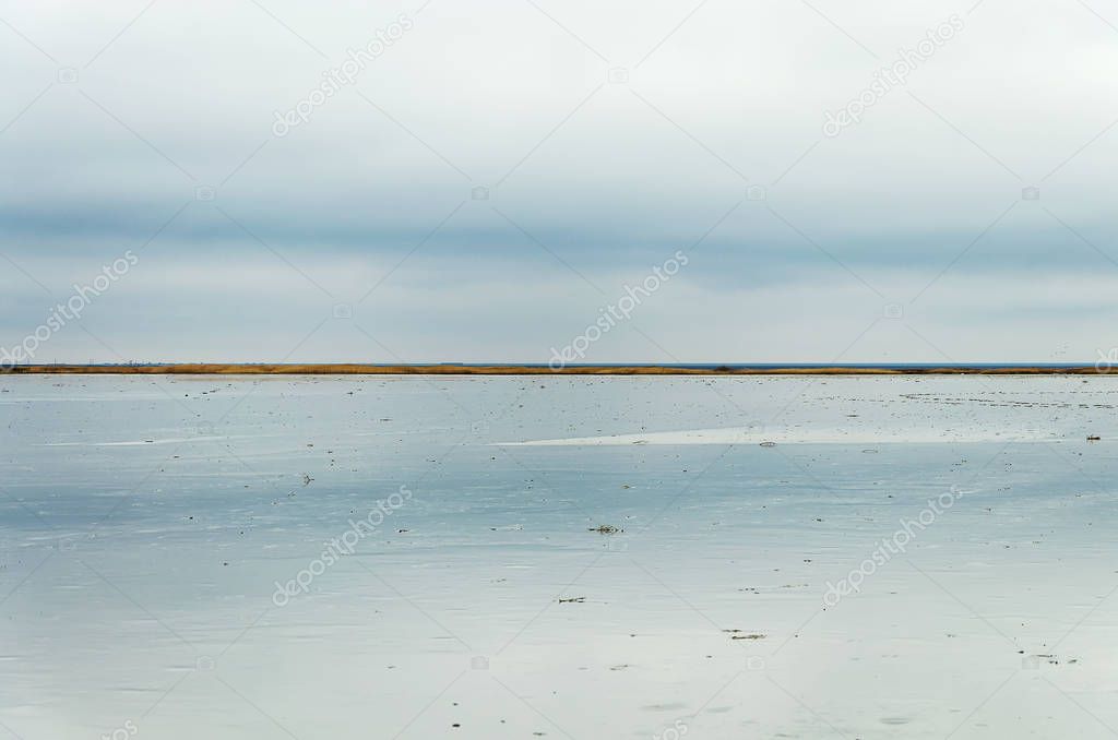 Morning on the lake, the clouds are reflected in the water. Salt Lake Elton, Russia, Volgograd Region.