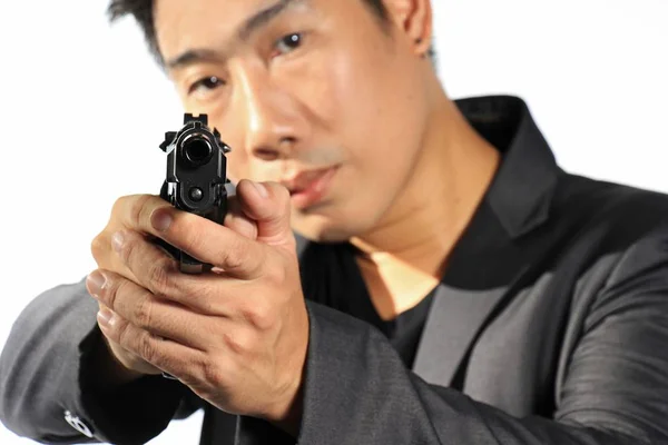 Asijský podnikatel zaměření s pistole — Stock fotografie