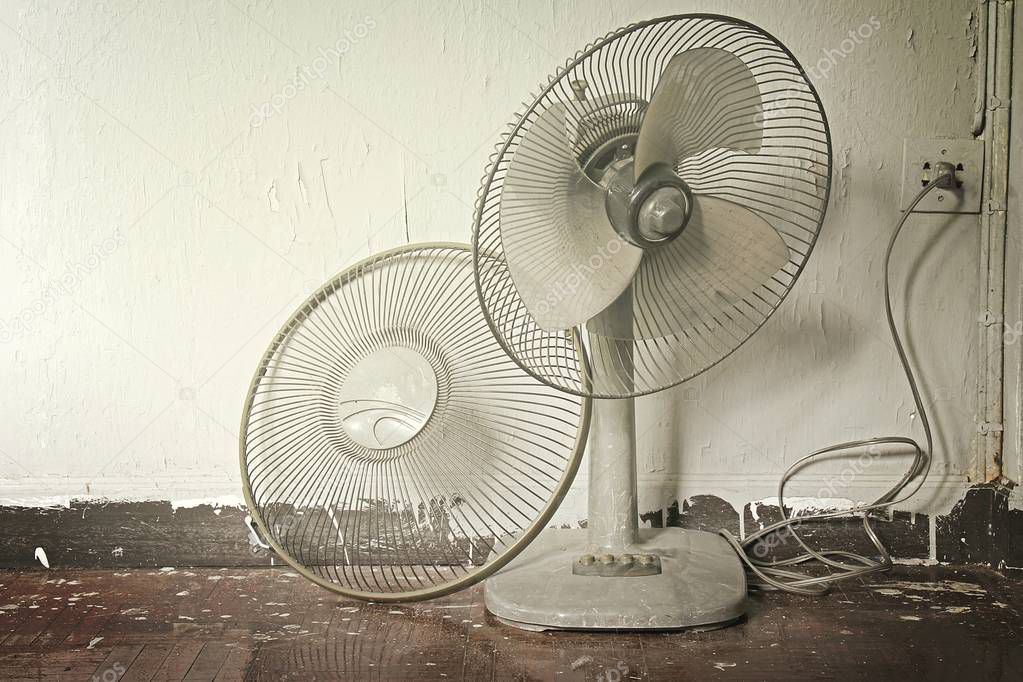 Dirty broken old electric fan in hot weather.