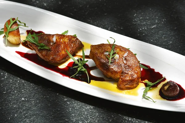 Foie gras grilled served with red berries sauce and chestnut. — Stock Photo, Image