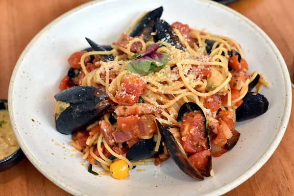 Pastas de mariscos en salsa arabiata, espaguetis con almejas y salsa de tomate picante . — Foto de Stock