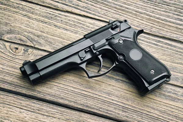 9mm pistol, Gun weapon series, Modern U.S. Army handgun M9 close-up on wooden background. (Color Processed)