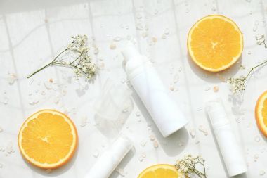Kozmetik köpük pompa şişe kapları ile taze portakal dilimleri, marka mock-up, doğal güzellik ürün kavramı için boş etiket.