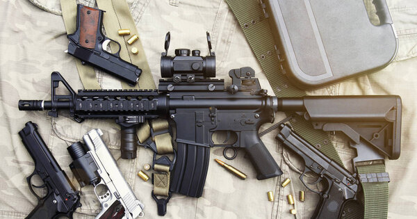 Оружие и военная техника для армии, штурмовая винтовка (M4A1) и пистолет на камуфляжном фоне
.