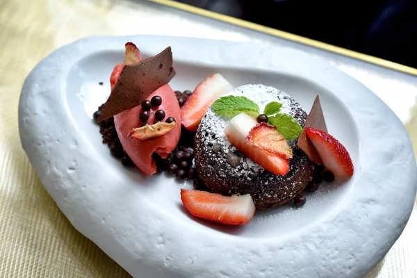 Chocolate dessert with red berries ice-cream, Chocolate lava cake with sweet summer fresh fruit, Molten chocolate cake, Top view.