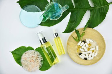 Yeşil bitkisel yapraklı kozmetik şişe kapları, markalaşma için boş etiket, doğal güzellik ürünü konsepti.