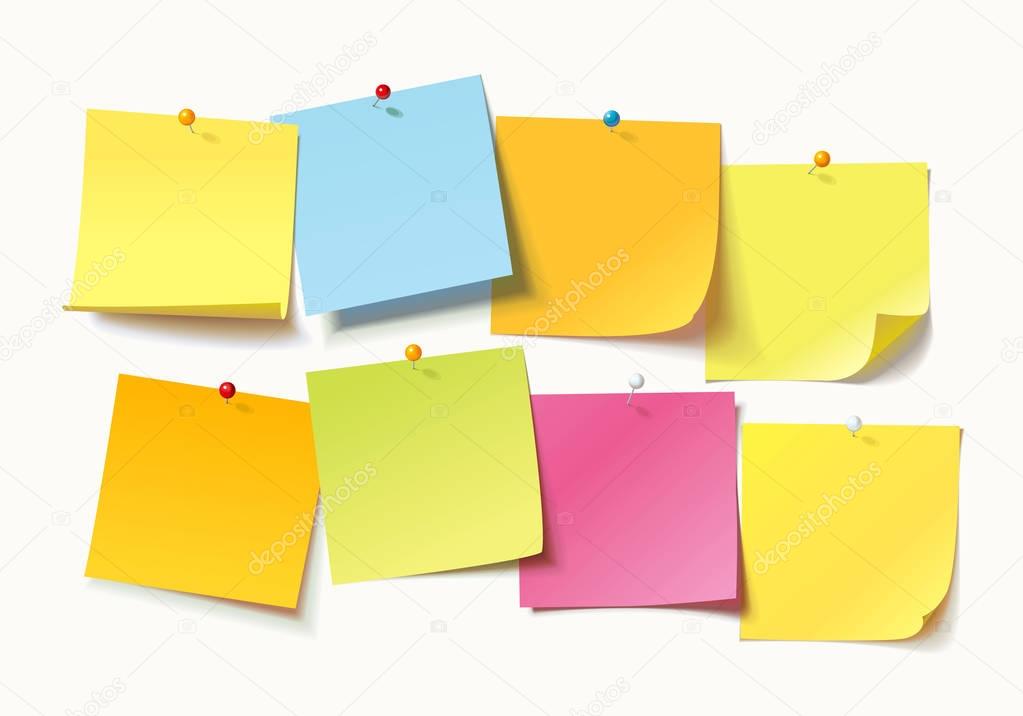 Colored sheets of note papers with curled corner and push pin