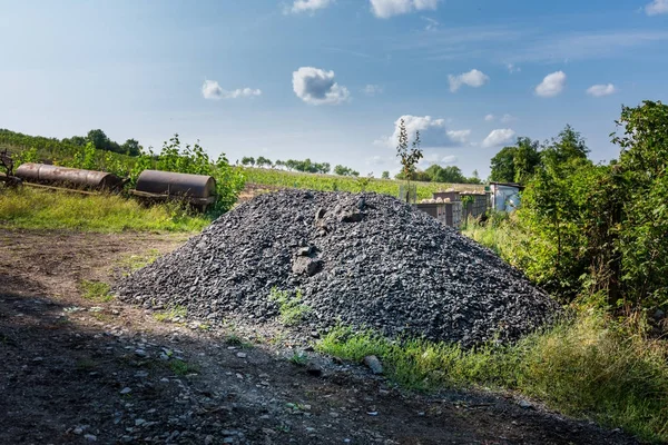 Železo kecy a odpadky poblíž zelený keř. Průmyslové prostředí a recyklation odpadu. Koše a korozi — Stock fotografie