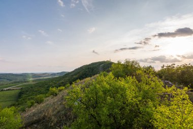 Günbatımı manzara panorama, altın saat tepelerde, Vadisi, güzel renkler ve bulutlar küçük köyde.