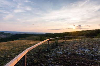 Günbatımı manzara panorama, altın saat tepelerde, Vadisi, güzel renkler ve bulutlar küçük köyde.