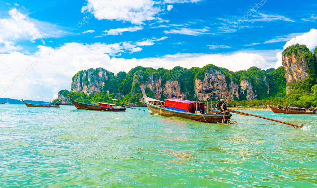 View from boat going to famous Railay beach in Krabi town, Thailand. Favorite place in Thailand with pure sea, white sand and beautiful limestone rocks. Vacation target in tropical paradise.