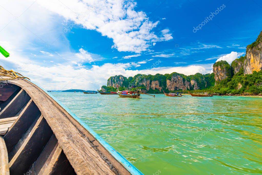 View from boat going to famous Railay beach in Krabi town, Thailand. Favorite place in Thailand with pure sea, white sand and beautiful limestone rocks. Vacation target in tropical paradise.