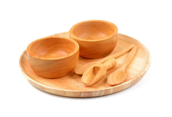 Tigela de madeira, prato de madeira e colher de madeira no fundo branco — Fotografia de Stock