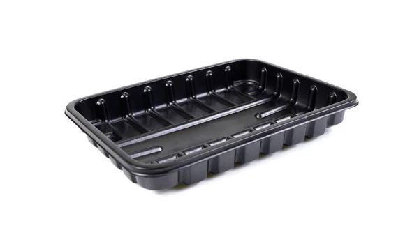 Черный пластиковый контейнер для еды на белом фоне, пластиковый пакет — стоковое фото