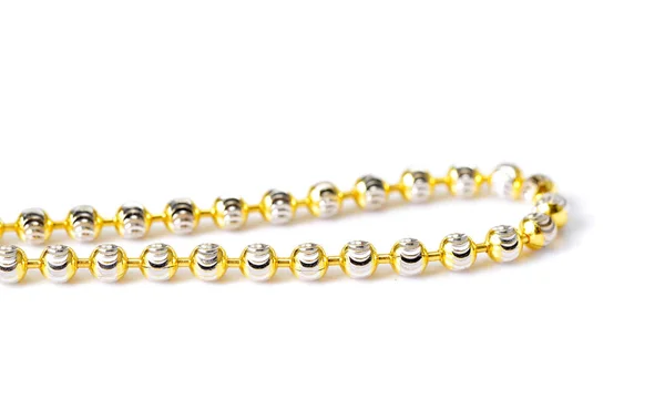 Gold necklace and gold bracelet on white background — Stock Photo, Image
