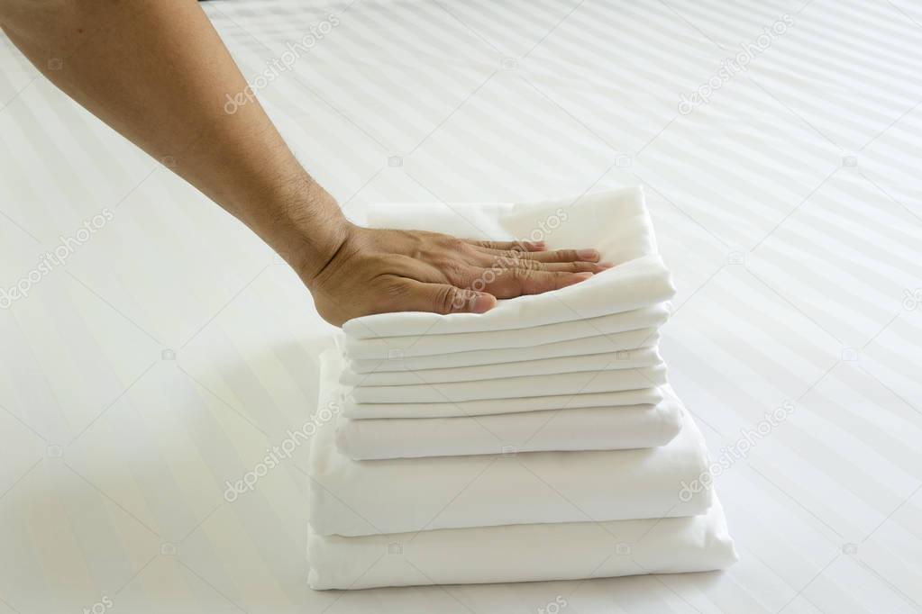 White pillowcase on white bed