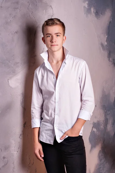 Πορτρέτο μόδας ενός αρσενικού έφηβου μοντέλου με λευκό πουκάμισο στο στούντιο Φωτογραφία Αρχείου