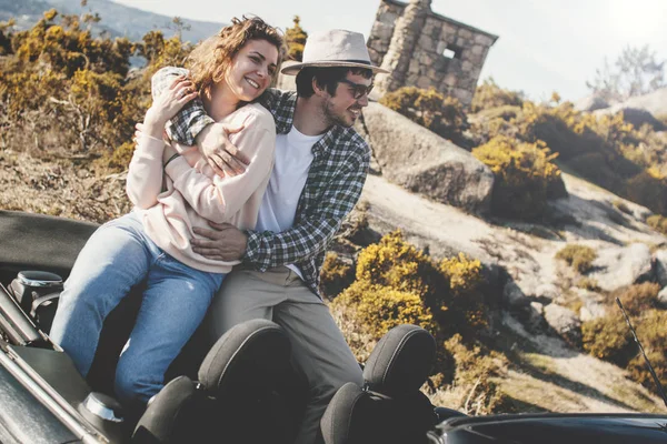 Beautiful couple in love travel on a cabriolet and admire the mo — Stock Photo, Image