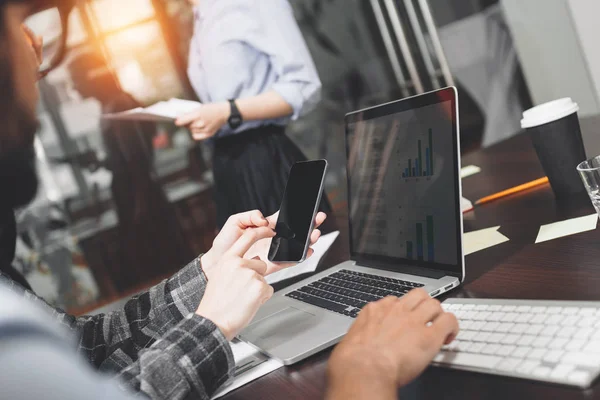 Geschäftstreffen junger Mitarbeiter im modernen Loft. Teamarbeit und Brainstorming. Gruppe von Managern, die an Laptops und elektronischen Geräten arbeiten. verschwommener Hintergrund, wenig Linsenschlag — Stockfoto