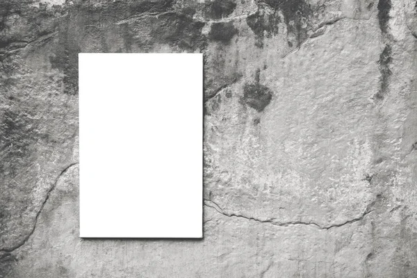 Vertical white mock-up of empty canvas on concrete wall