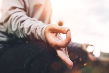 Genç kız Şehir Parkı yeşil çim üzerinde Yoga pratik. Güzel kadın kentsel alanda meditasyon portre. Yatay, bulanık arka plan, lens flare etkisi