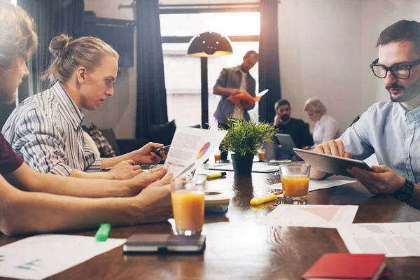 Forretningsfolk som jobber og møtes på loftsplassen. Gruppe av medarbeidere diskuterer nytt prosjekt og brainstorming i møterommet – stockfoto