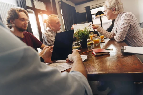 Reunión de lluvia de ideas en la oficina. Jóvenes compañeros de trabajo trabajan juntos en el estudio. Concepto de trabajo en equipo y gadgets — Foto de Stock